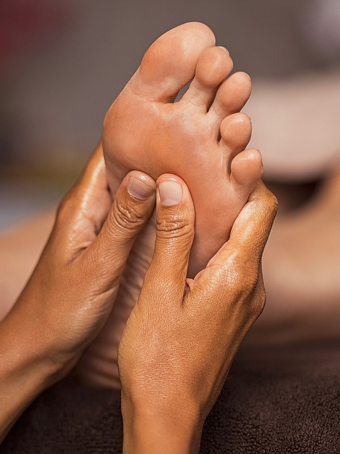 Foot massage therapy in a wellness setting.