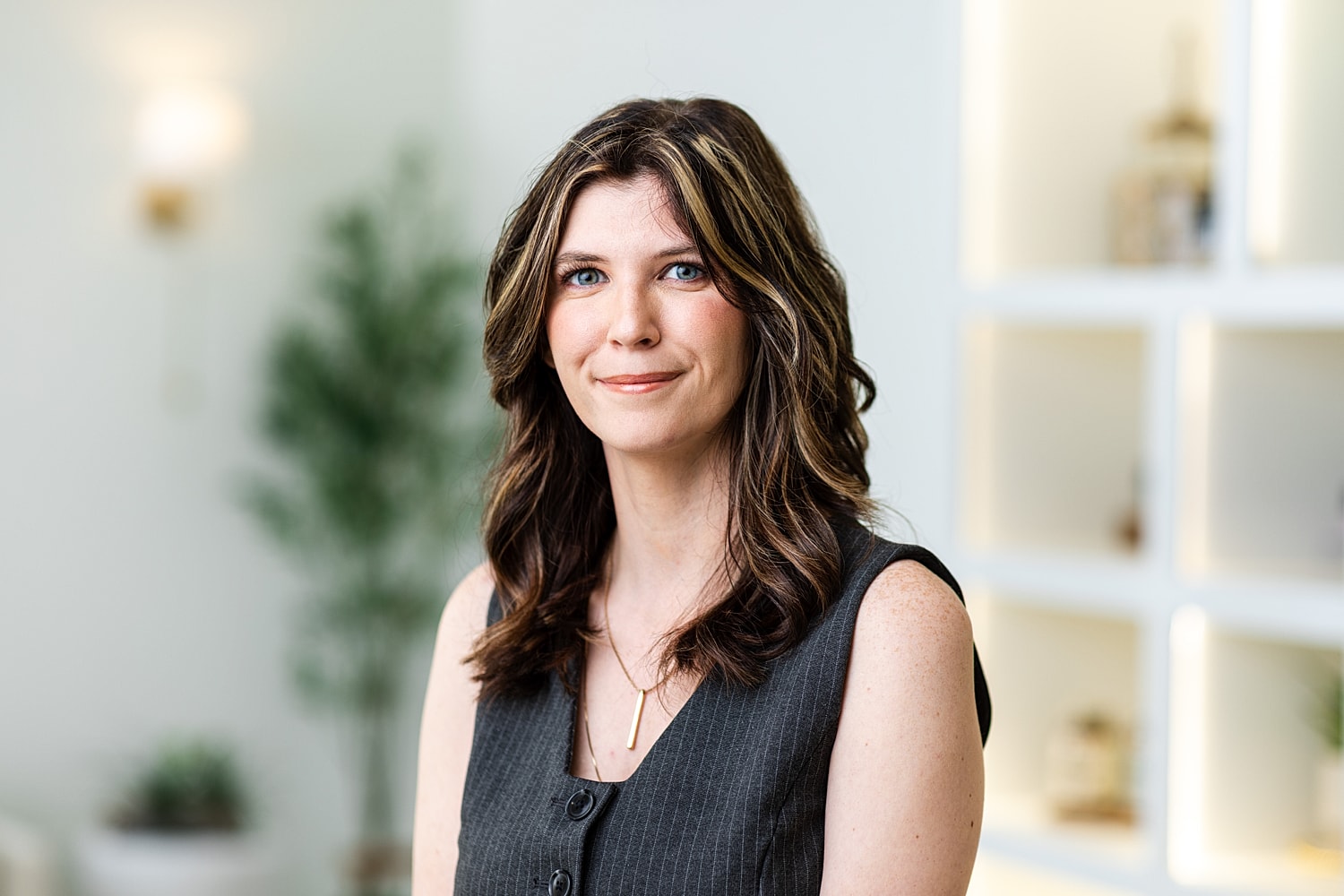 Woman laughing in a black and white portrait.