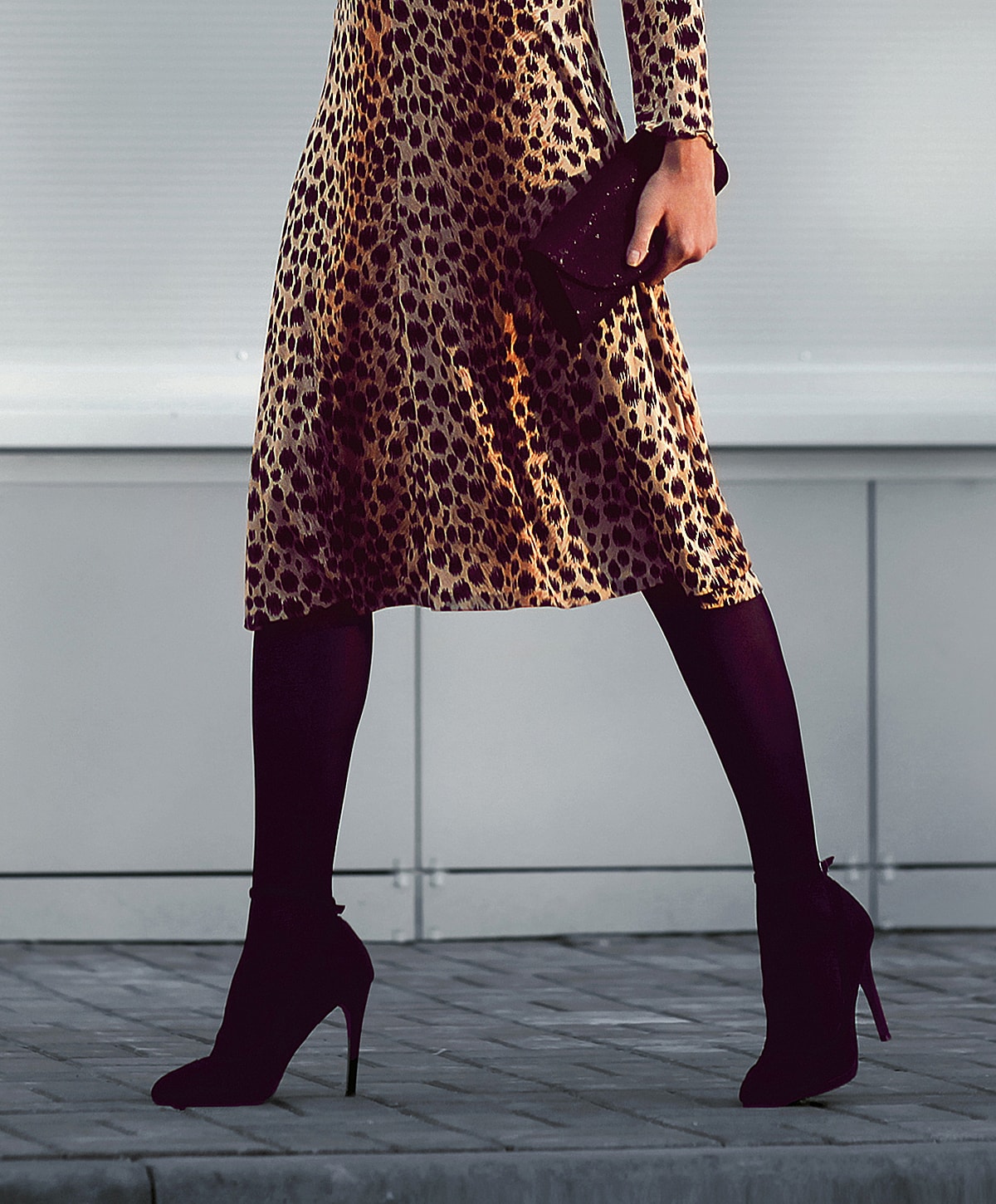 Woman in leopard print dress and high heels.