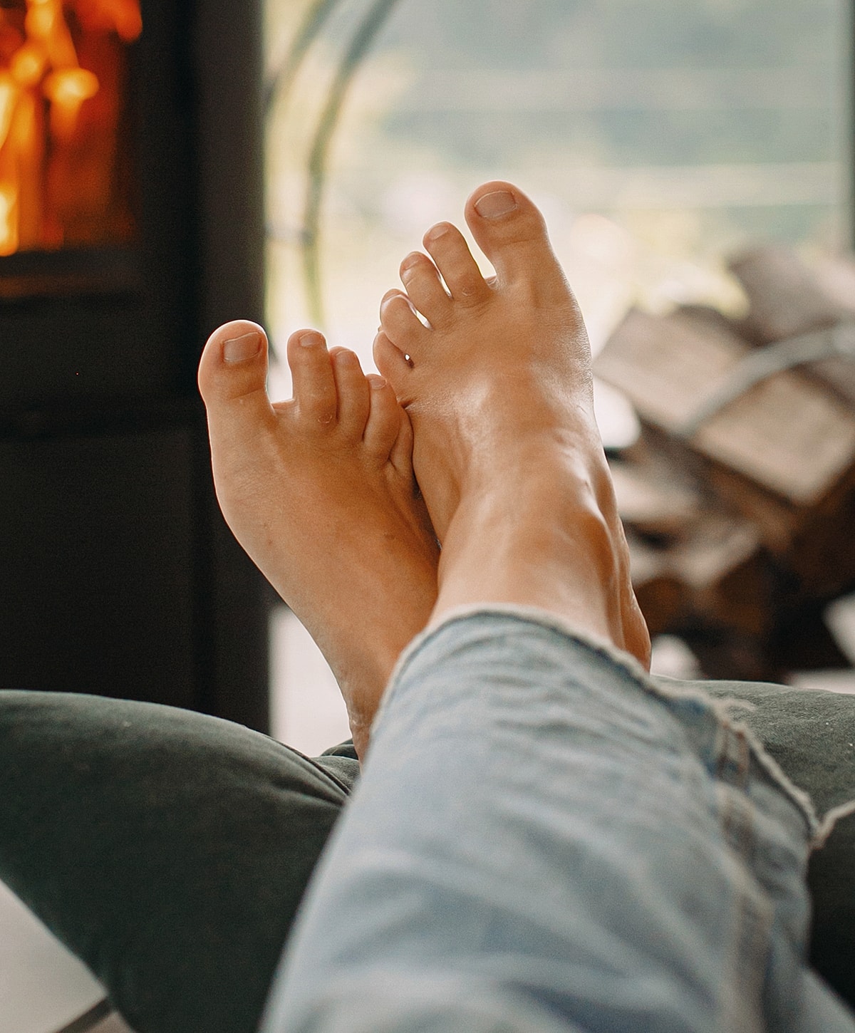 Relaxed feet resting by the fireplace.