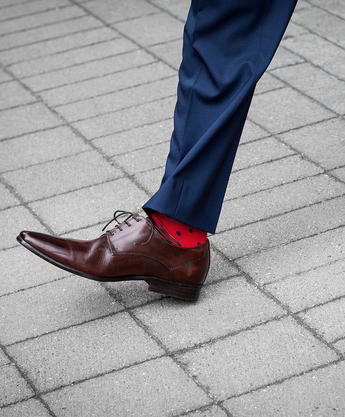 Brown shoe and red polka dot socks.