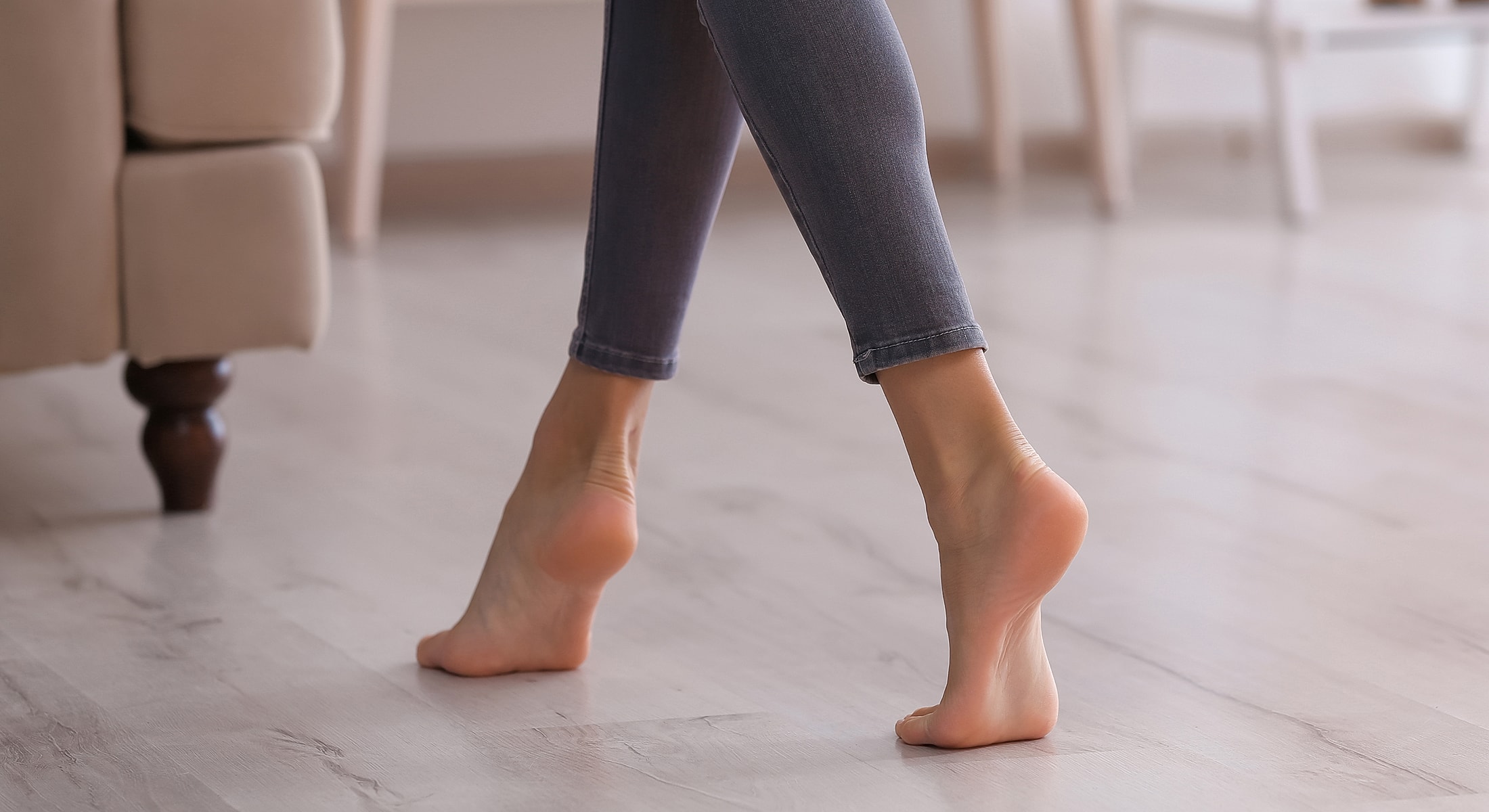 Bare feet walking on wooden floor.
