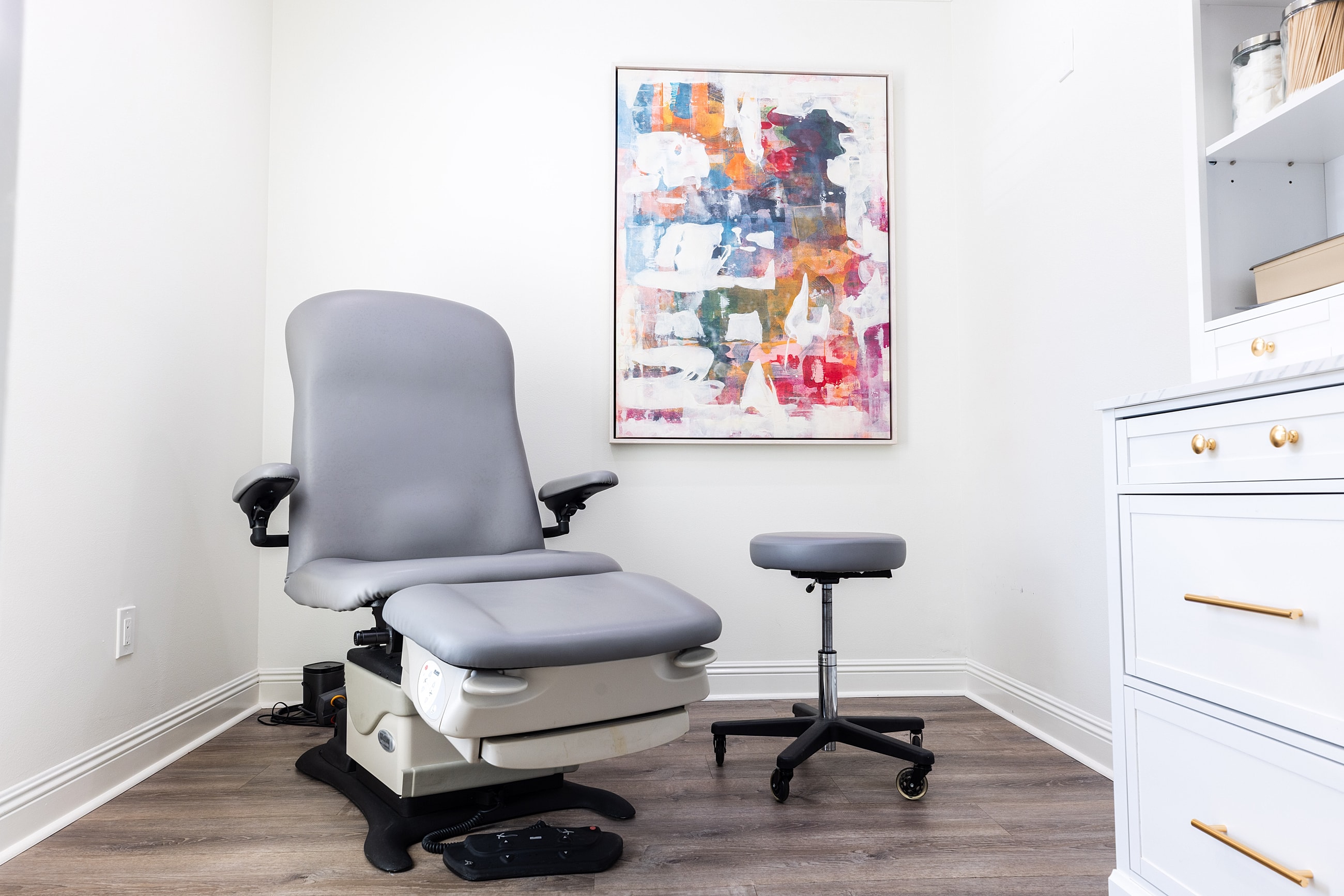 Woman adjusting black high heels outdoors.