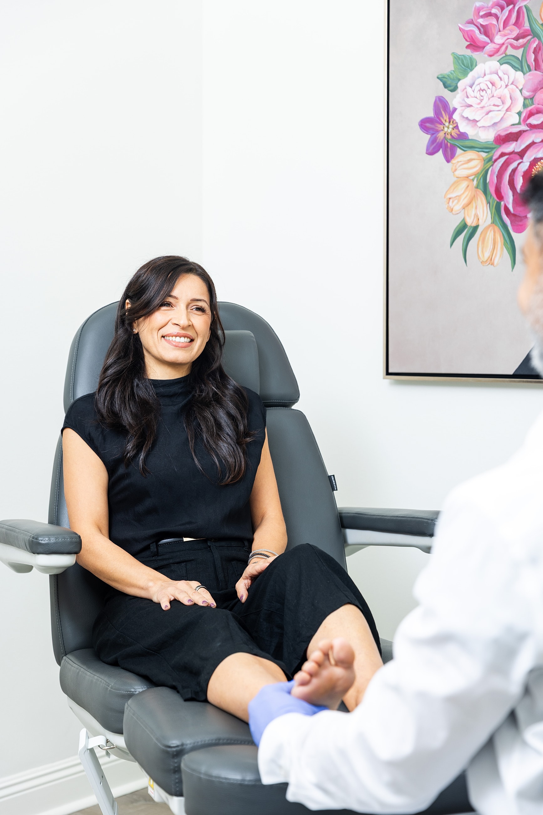 Woman in chair during medical consultation.
