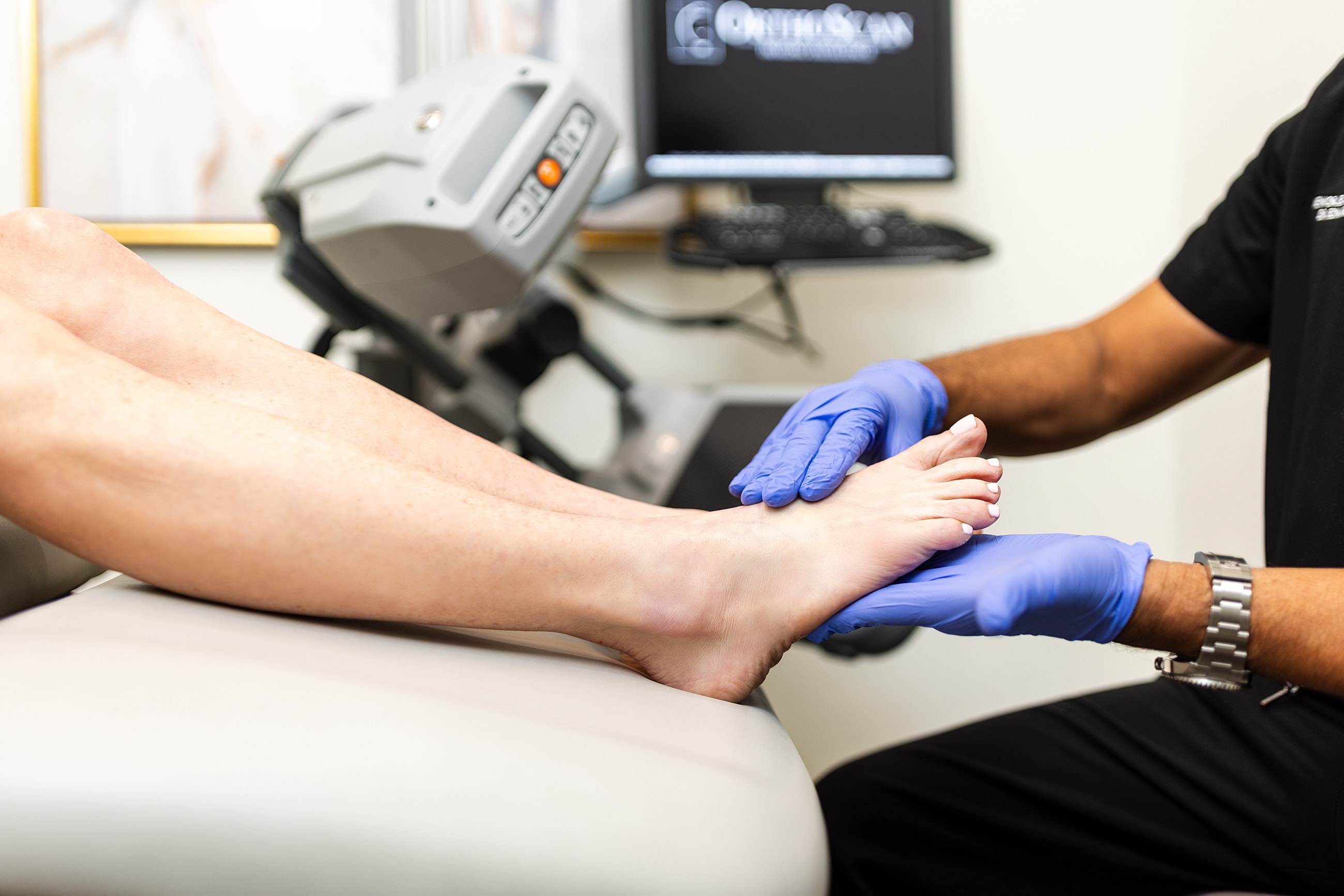 Black high-heeled sandals on a woman's foot.
