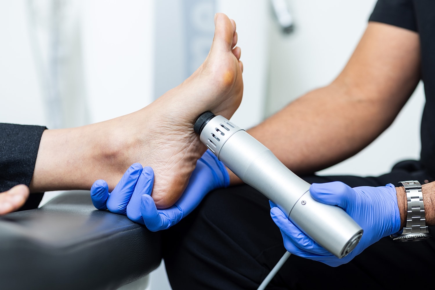 Foot treatment with medical device and gloves.