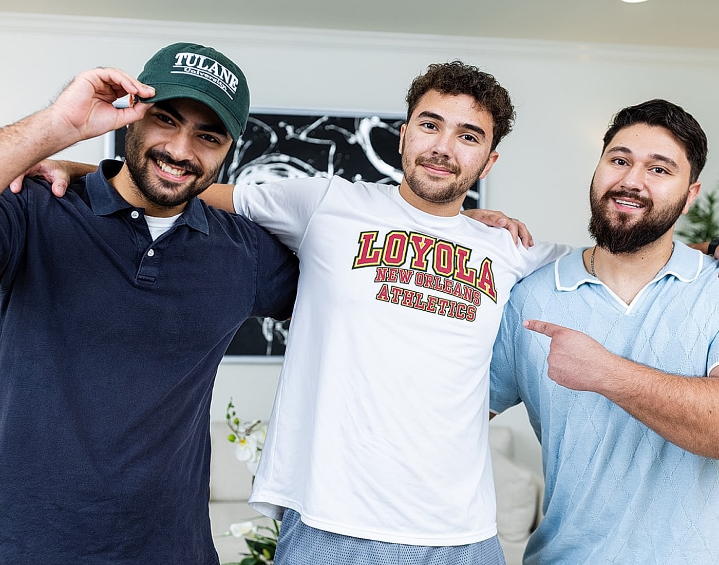 Three friends celebrating school spirit indoors.