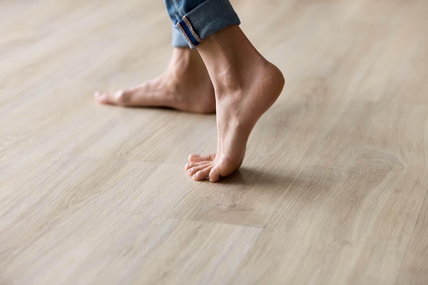 Bare feet on wooden floor.