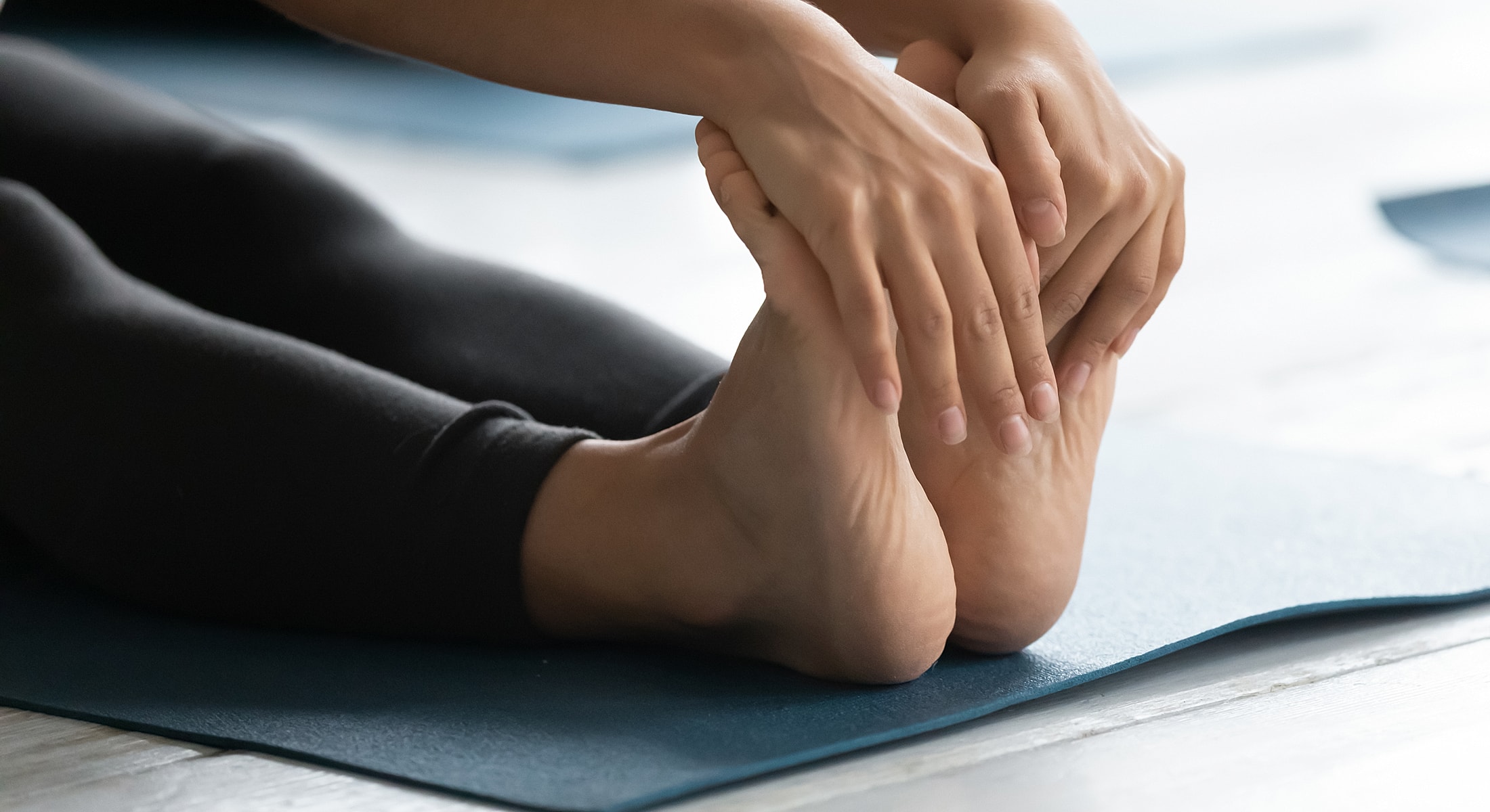 Person stretching on a yoga mat.