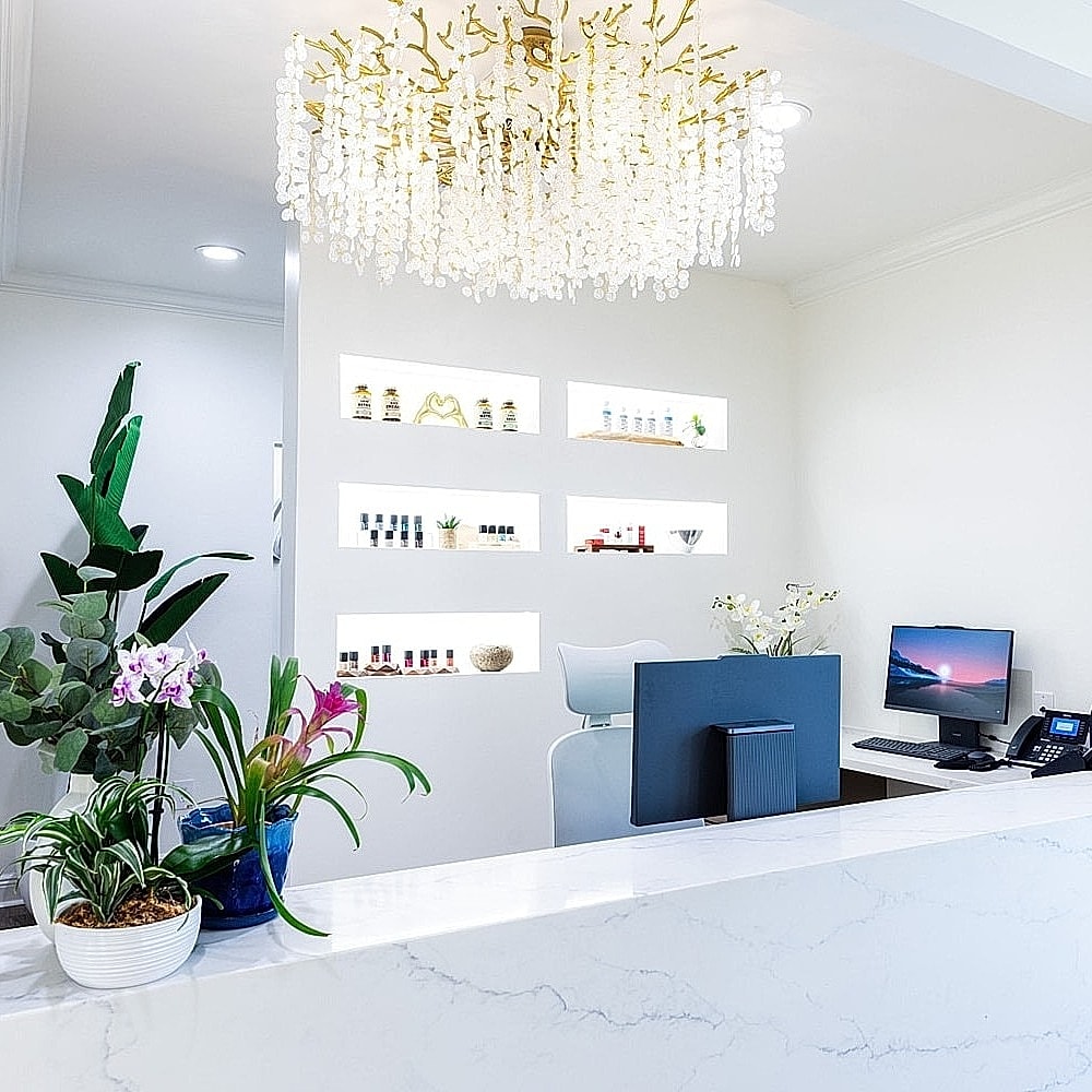 Elegant reception area with plants and products.