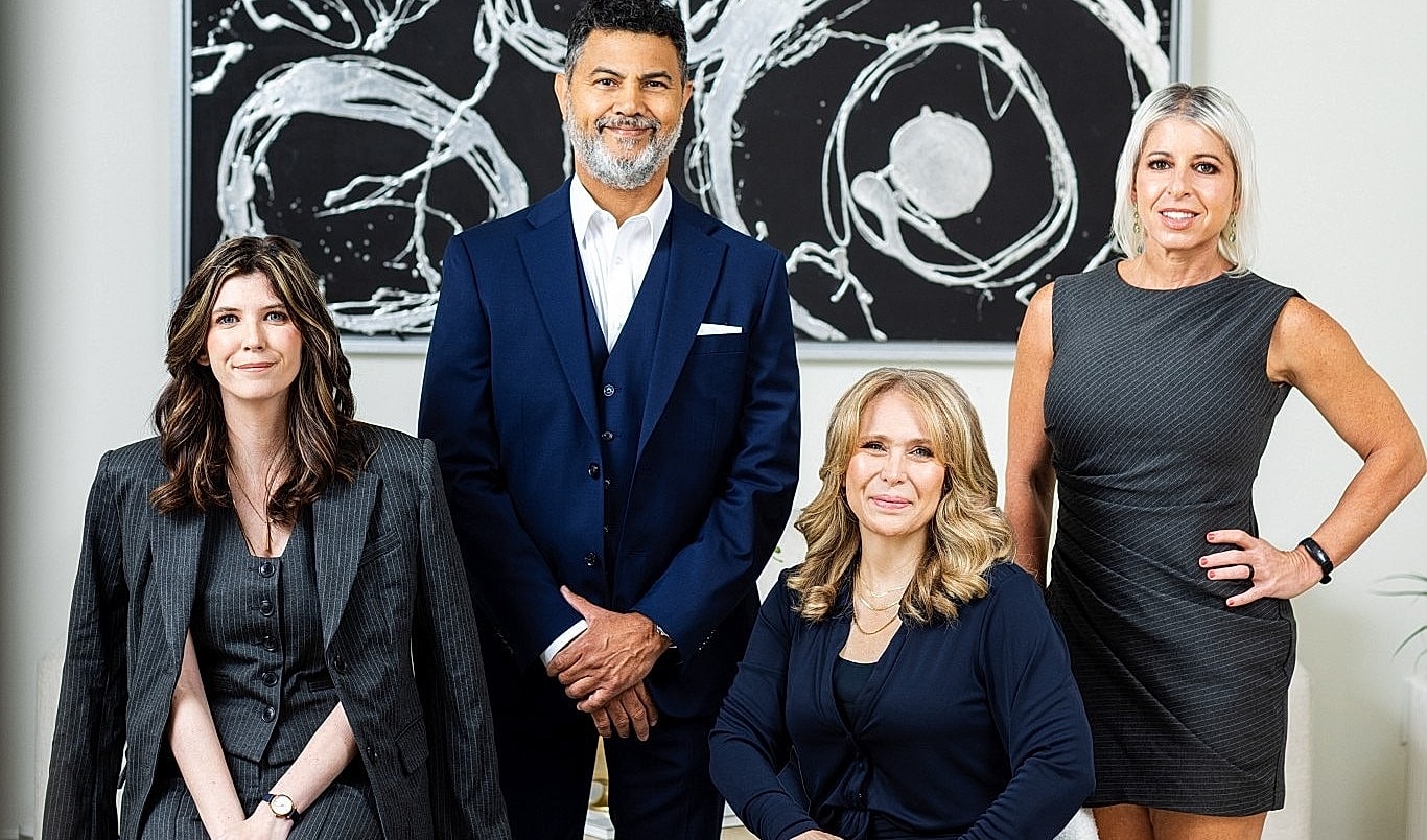 Professional group portrait in modern office setting.